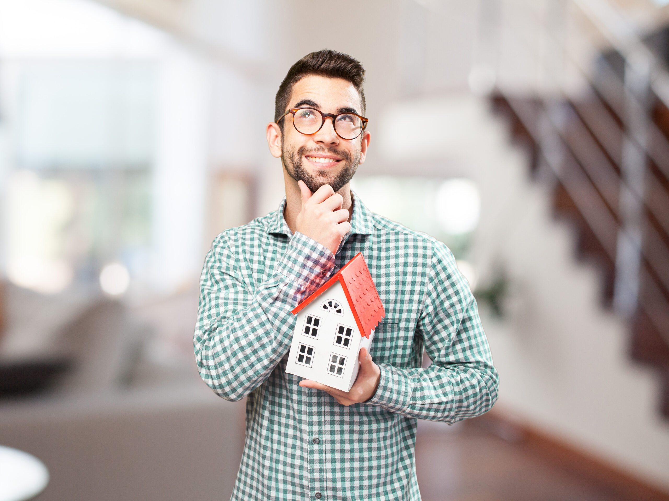 estate agency in Glasgow man holding a house